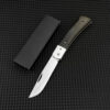 A small wood handle folding knife displayed next to a black box.