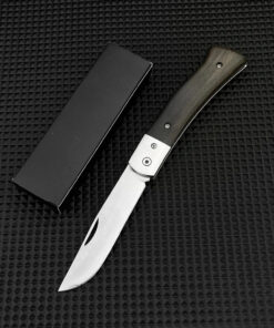 A small wood handle folding knife displayed next to a black box.
