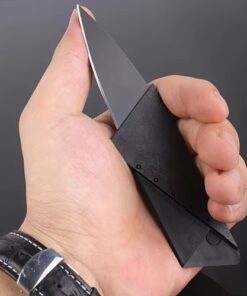 A man's hand holding a slim folding credit card knife.