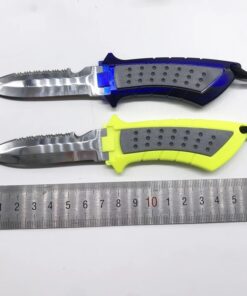 Two diver's knife models of differing colors displayed next to a steel ruler.