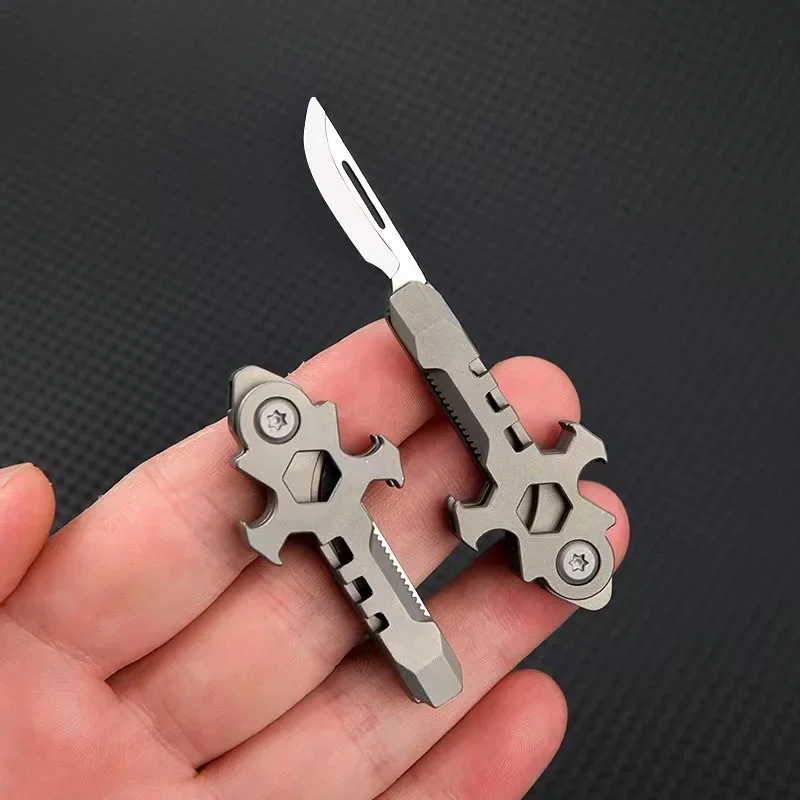 Keyring Knife A man's hand holding a mini keyring knife multi tool.