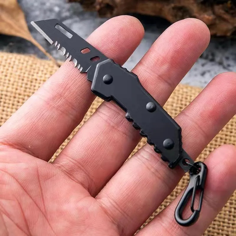 Mini Pocket Knife Keychain A man's hand holding a mini pocket knife keychain