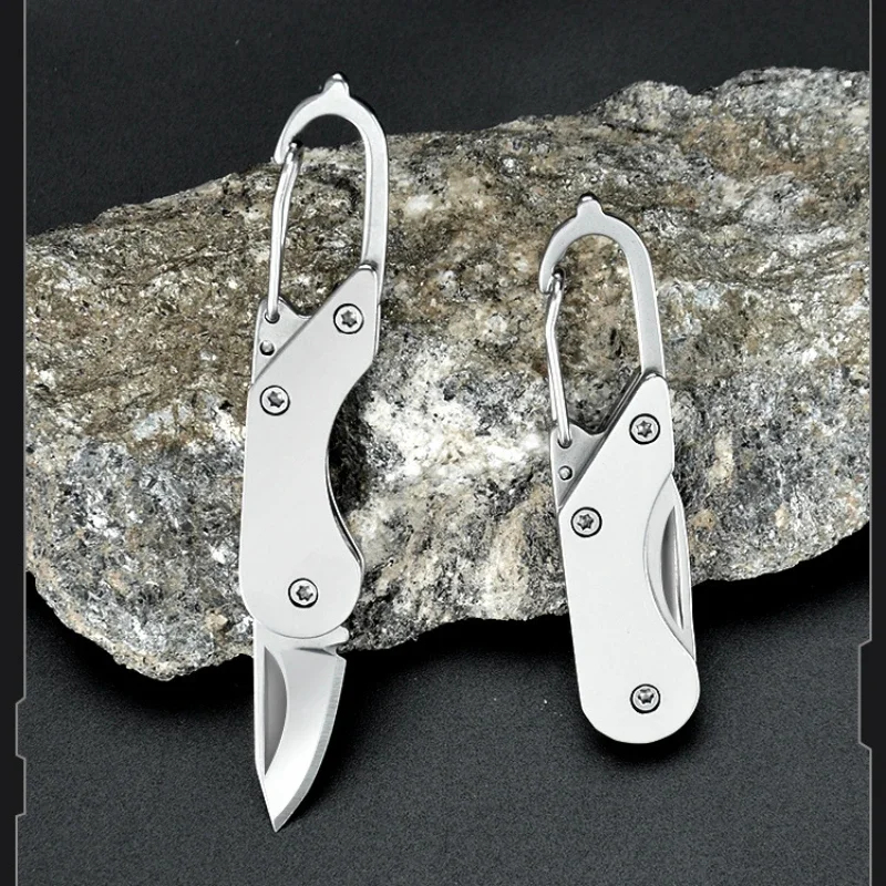 Small Keychain Knife A small keychain knife displayed leaning against a rock.