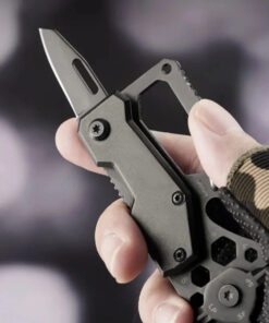 A man's hand holding a small multitool knife.