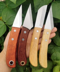 A man's hand holding four professional garden knife models of differing design and color.