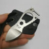 A man's hand holding a small neck knife and its mini sheath.