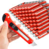 A man's hand holding a snap off utility knife, with a bulk pile of utility box cutter knives in the background.