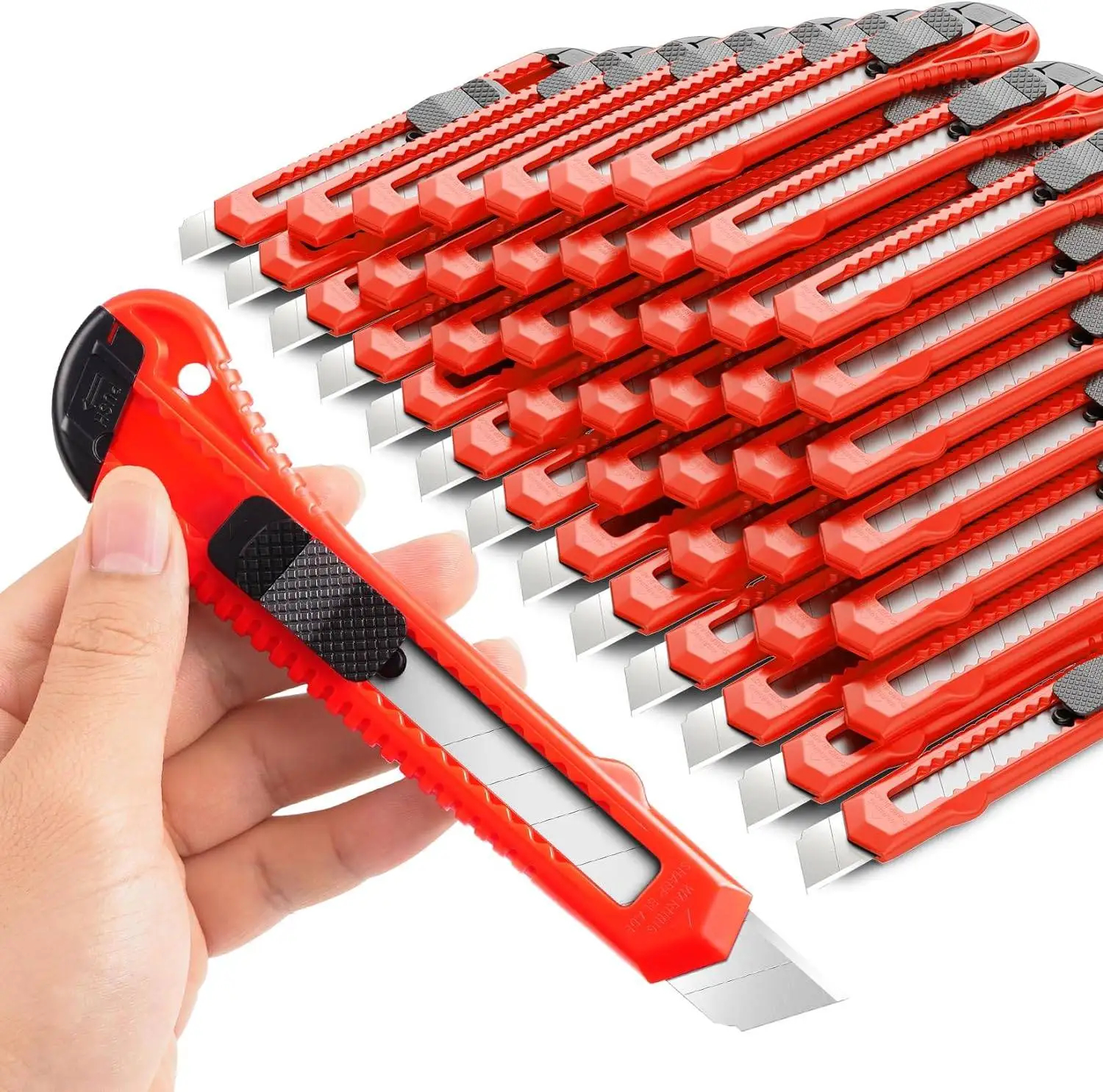 Snap Off Utility Knife A man's hand holding a snap off utility knife, with a bulk pile of utility box cutter knives in the background.