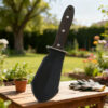 A Hori Hori Garden soil knife tool.
