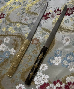 Two Kogatana small Japanese knife models displayed against silk cloth.