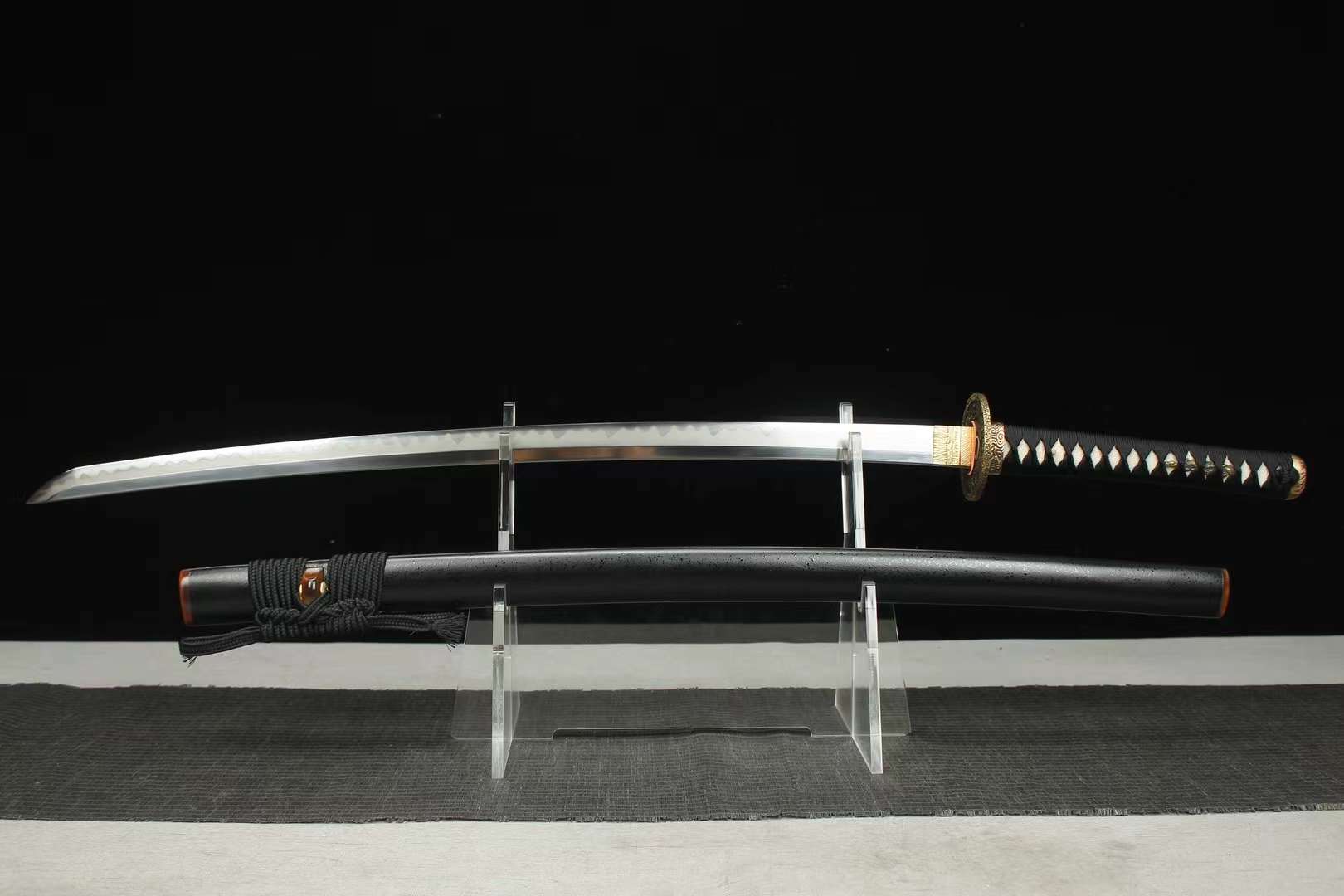 Black Dragon Katana Sword A black dragon Katana sword, displayed on a small stand alongside its scabbard.
