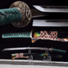 A demon slayer Katana real weapon, displayed on a small stand, alongside its scabbard.
