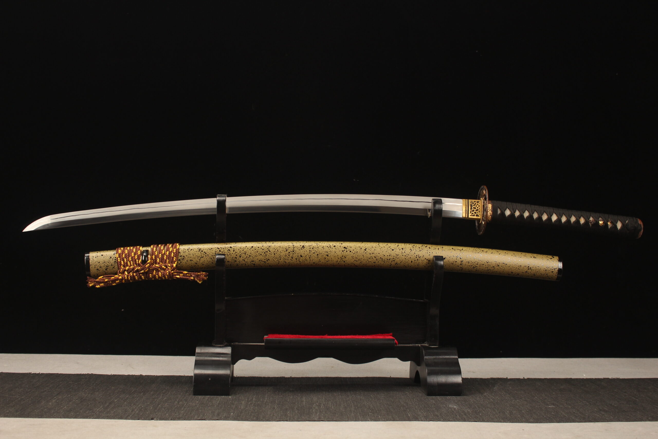 Longquan Tiger Katana A Longquan tiger Katana sword, displayed on a small wooden stand, alongside its scabbard.