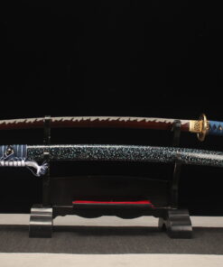 A red blade Katana sword, displayed on a small wooden stand, alongside its scabbard.