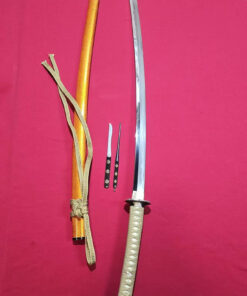 A hand forged Tamahagane steel Katana displayed next to its scabbard, Kogai hair needle and Kogatana knife.