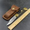 A folding lockback knife with blade opened next to its leather poch and a measurement ruler.